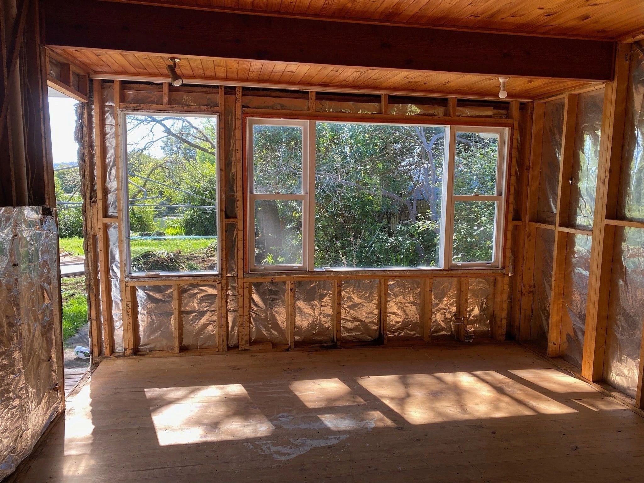 Wooden sunroom with forest views