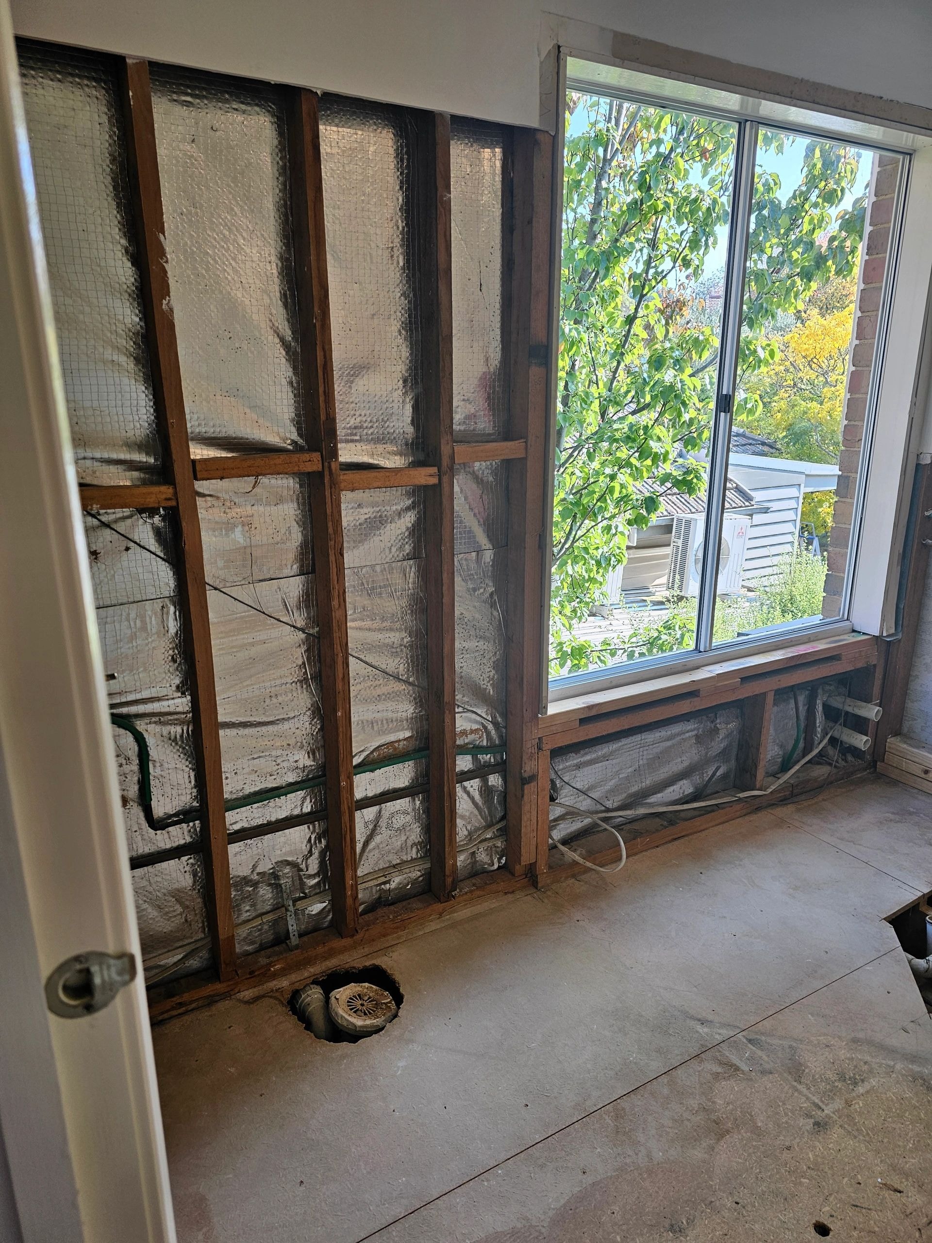 Old wooden screen doors next to window
