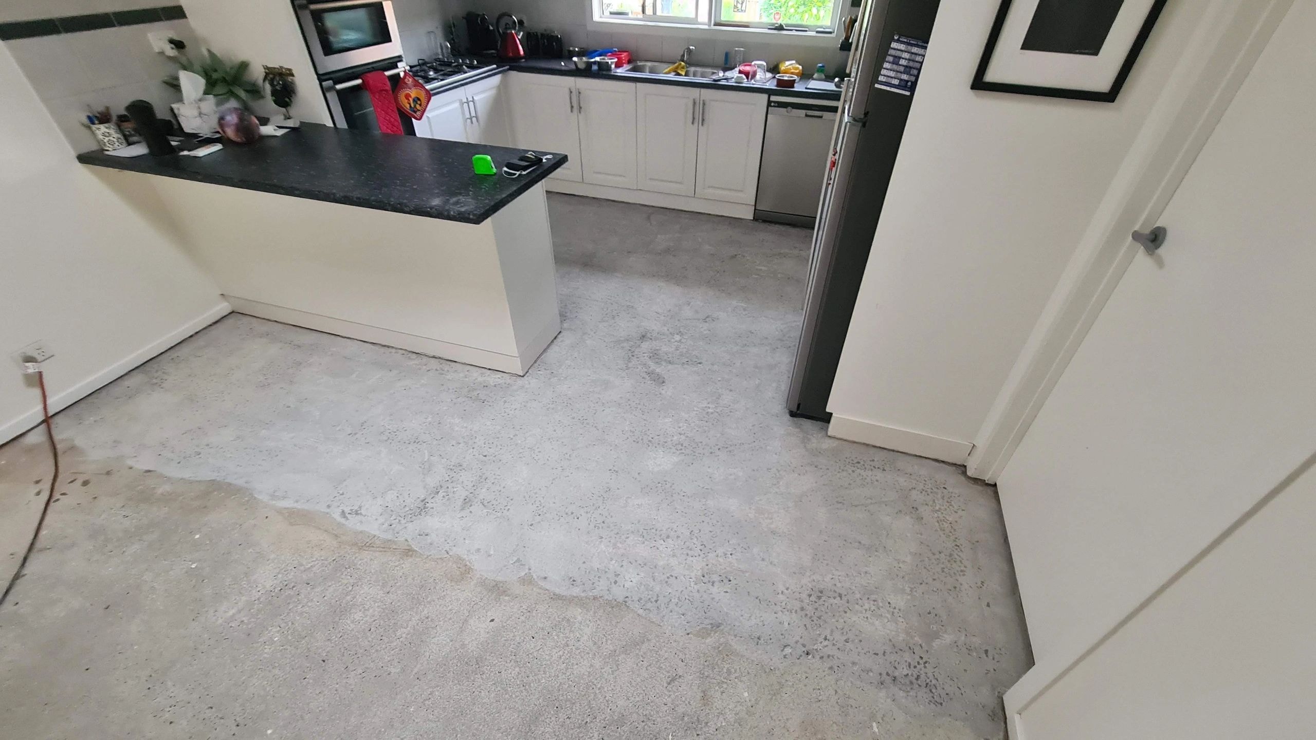 Modern kitchen with concrete flooring